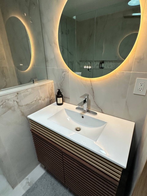 Vanity with backlit round mirror
