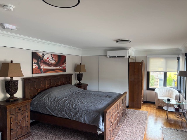 Bedroom with armchair by the window