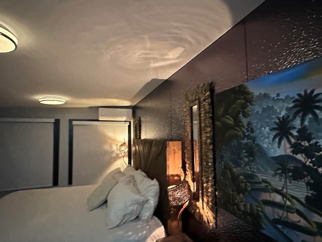 Tropical mural wall beside the bed