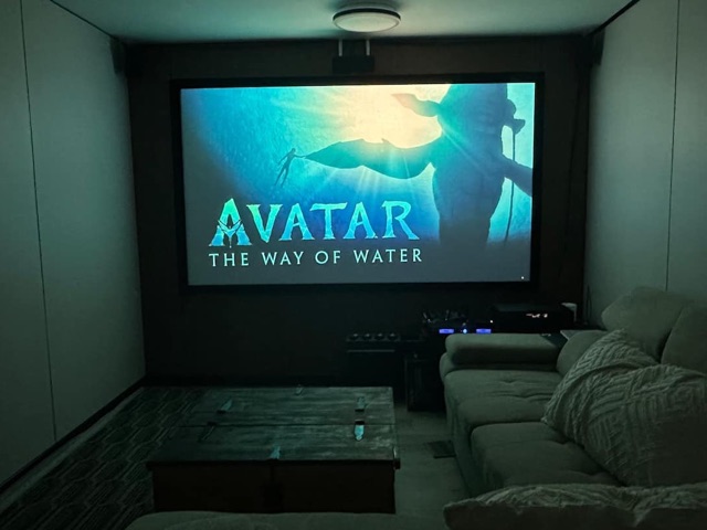 Cinema room with 110-inch projector screen and sectional sofa